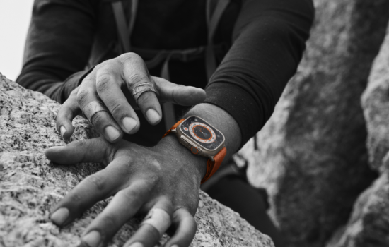 Hand on a rock whilst wearing Apple Watch Ultra.