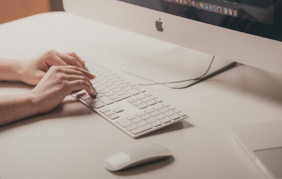 Person typing on a Mac