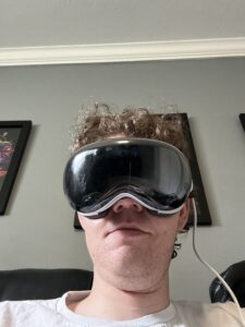 Appleosophy writer Jacob Sedesse wearing Apple Vision Pro with the crackgate crack on the front.