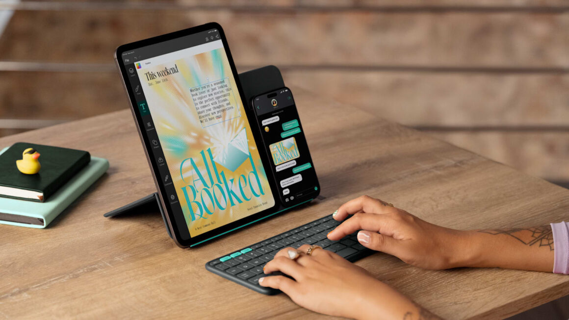 Apple iPhone and iPad on a stand with a person typing on a keyboard.