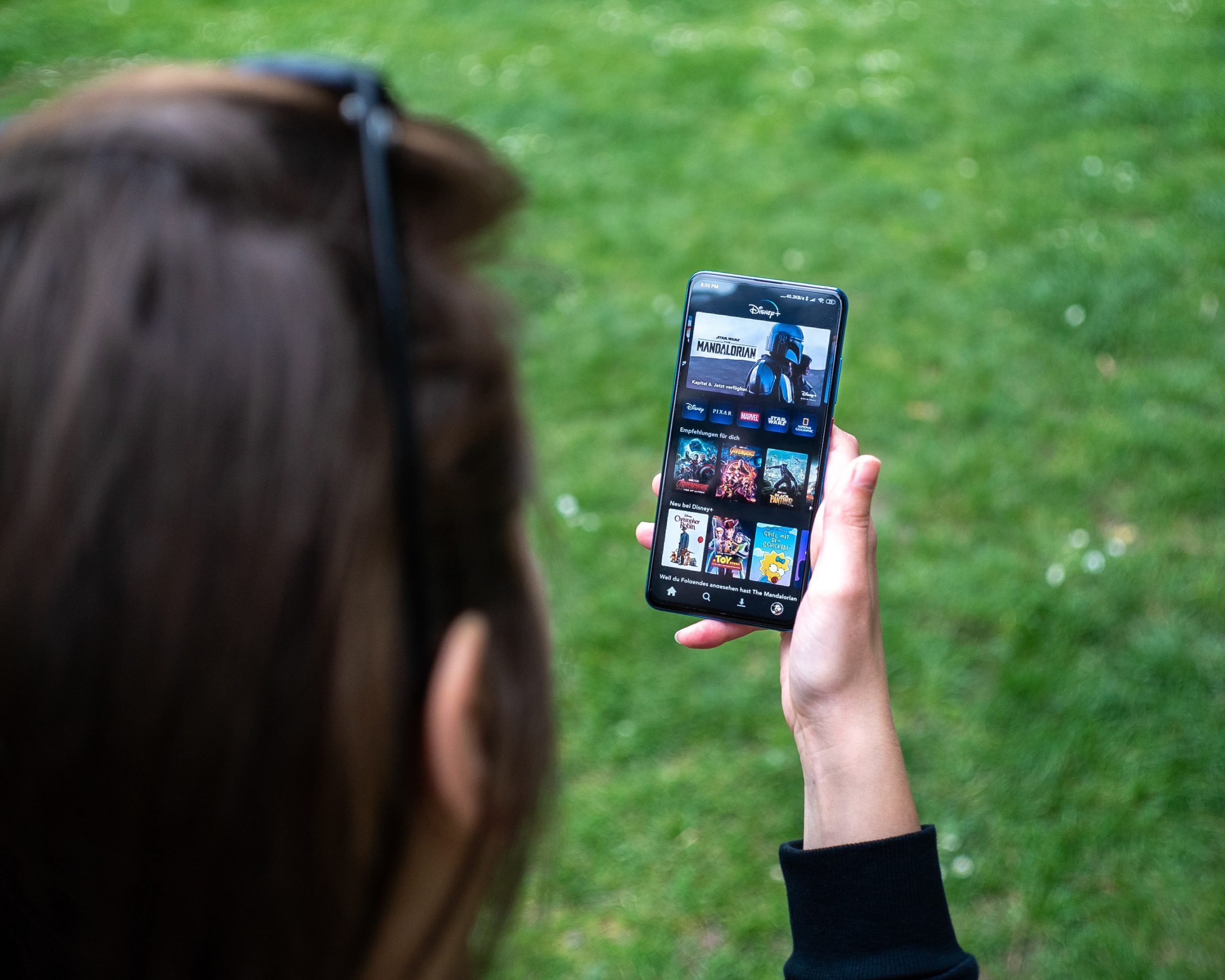 Woman holding iPhone in the park