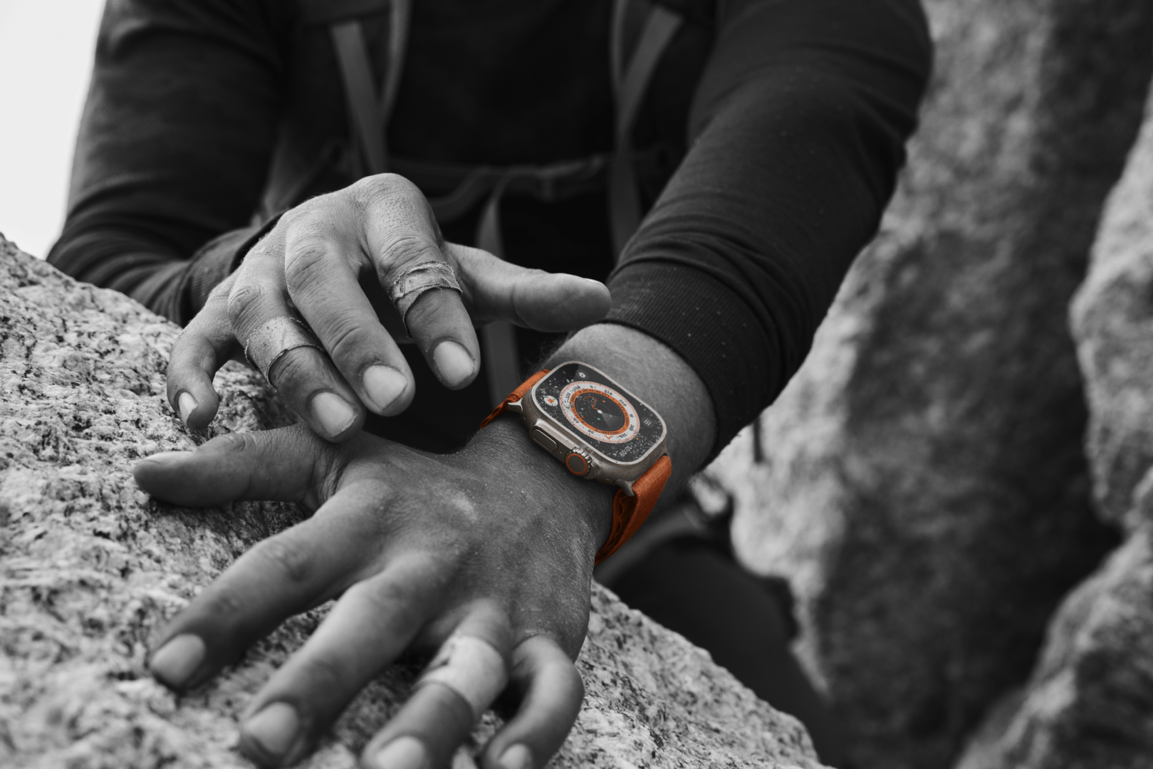 Hand on a rock whilst wearing Apple Watch Ultra.