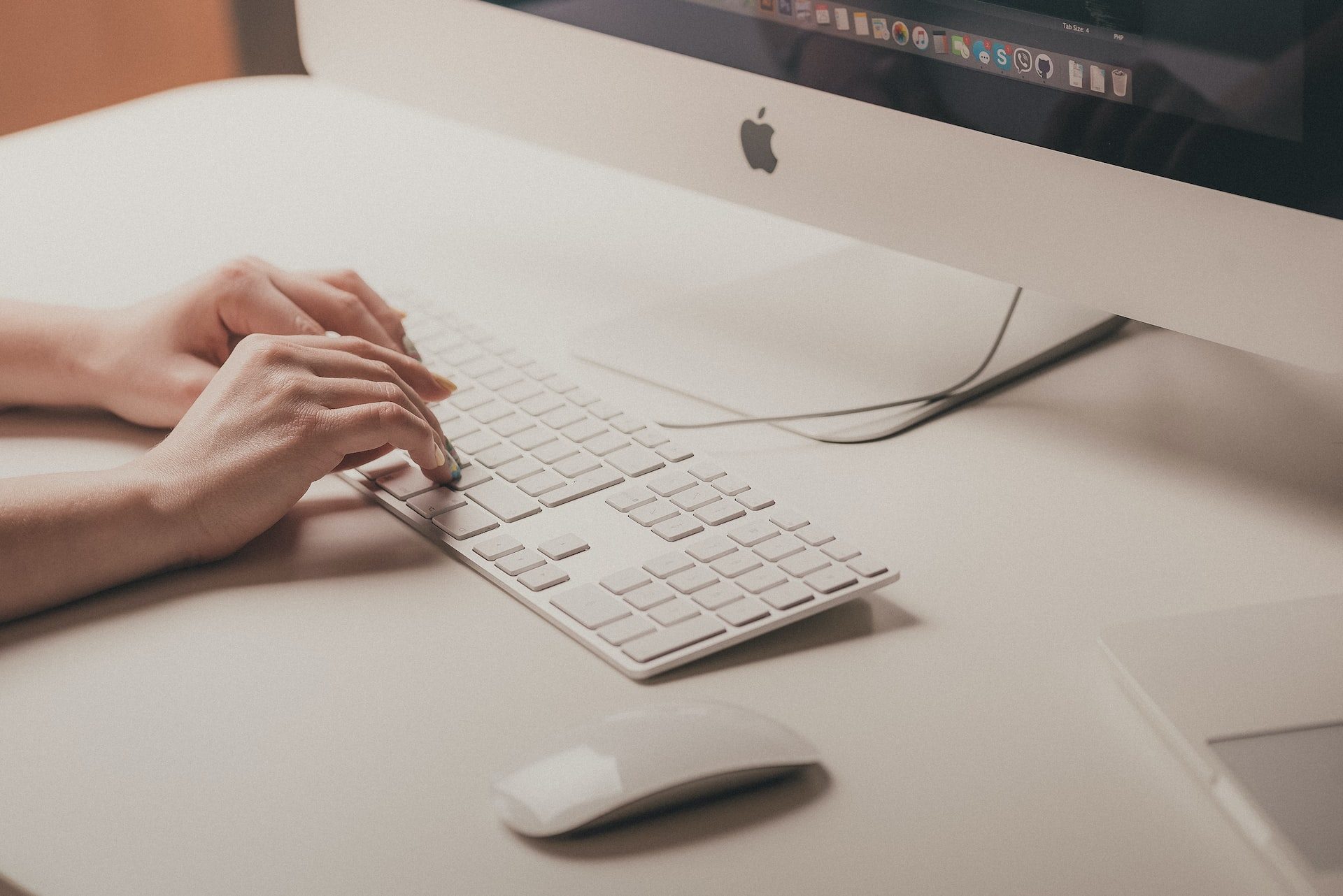 Person typing on a Mac