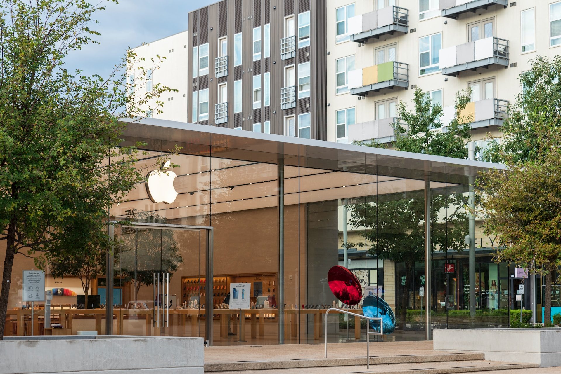 Apple Store with trees and cityscape.