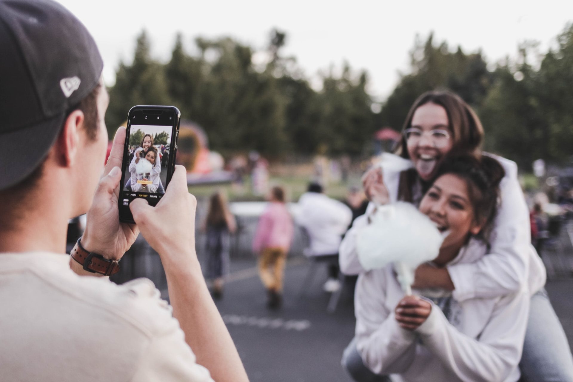 Man taking photo of two girls together.