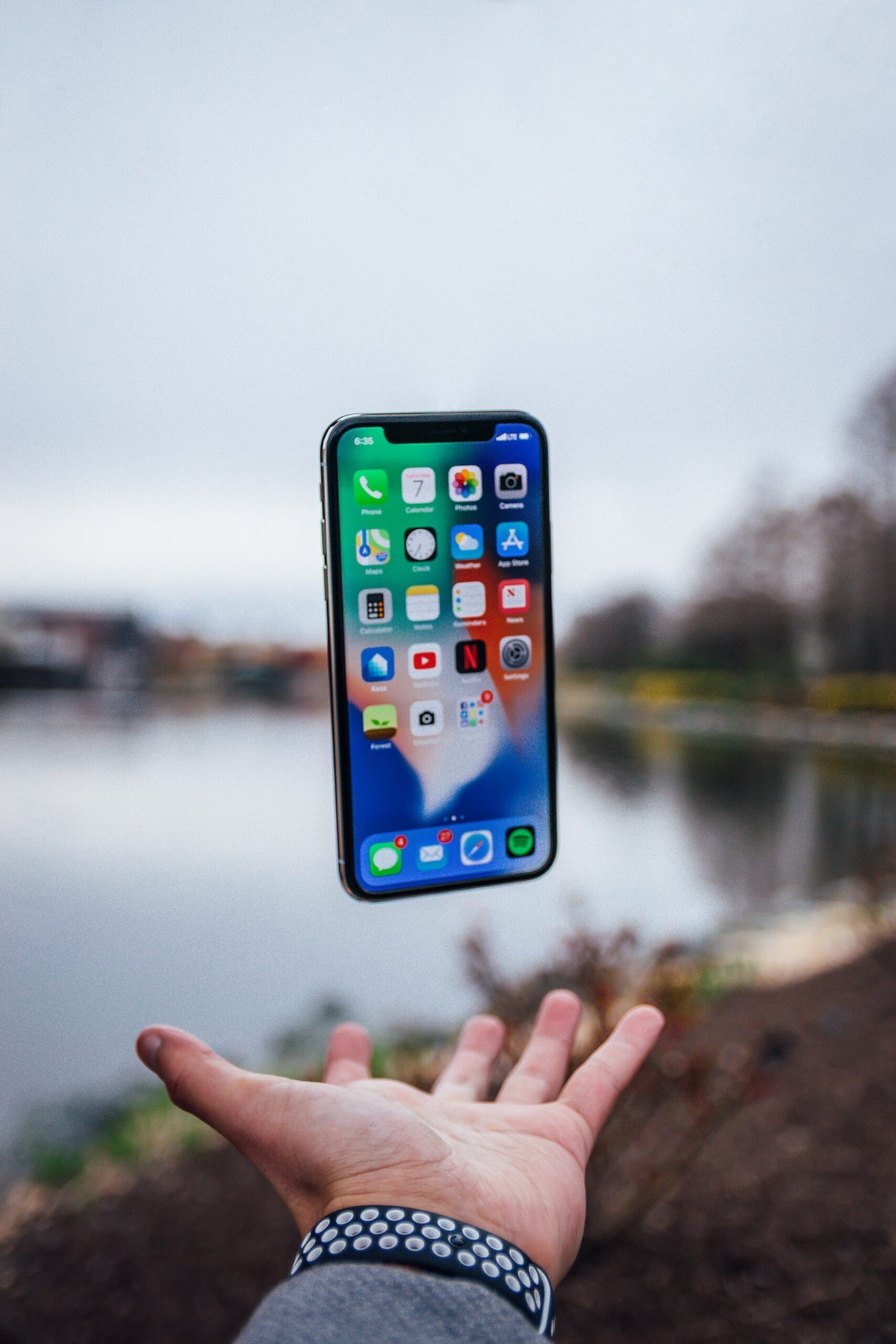 Man throwing iPhone in the air.