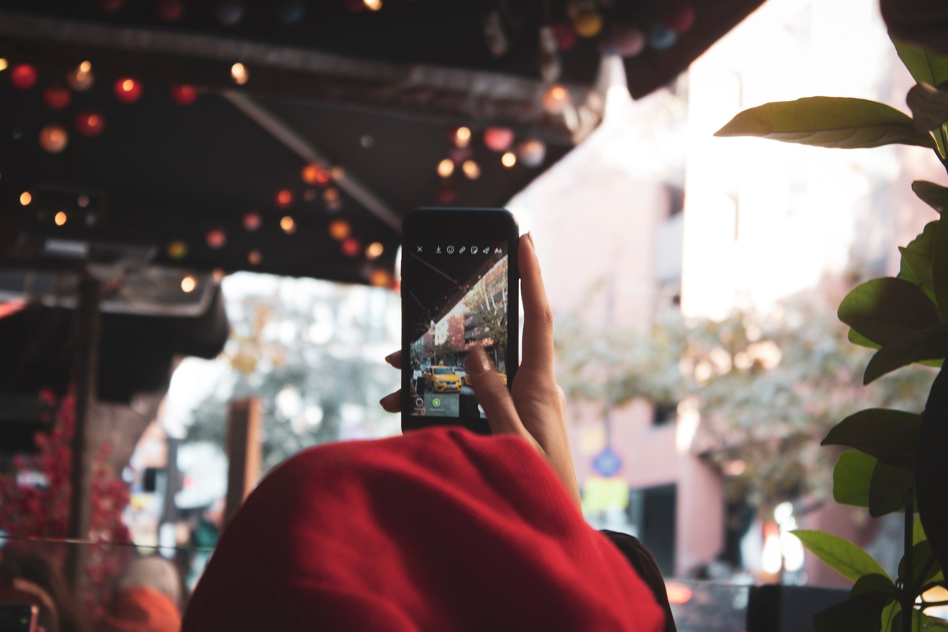 Man taking photo using Instagram camera app.