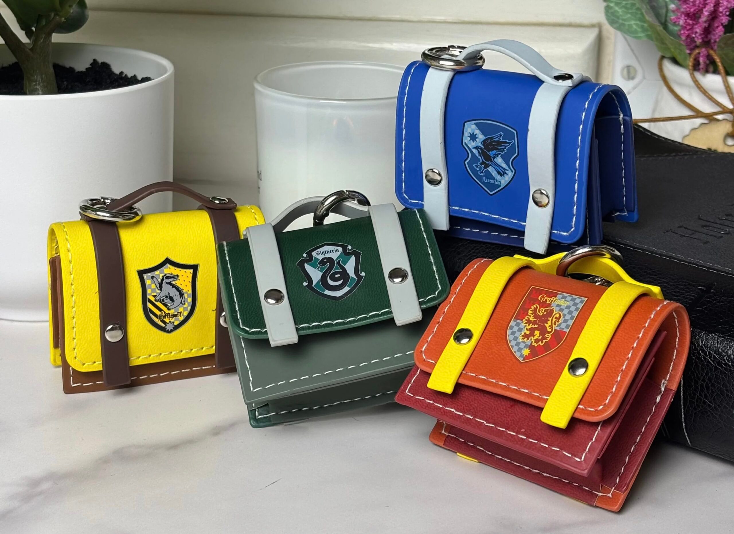 Wizarding World fans can show off their Hogwarts House Pride with these AirPods cases