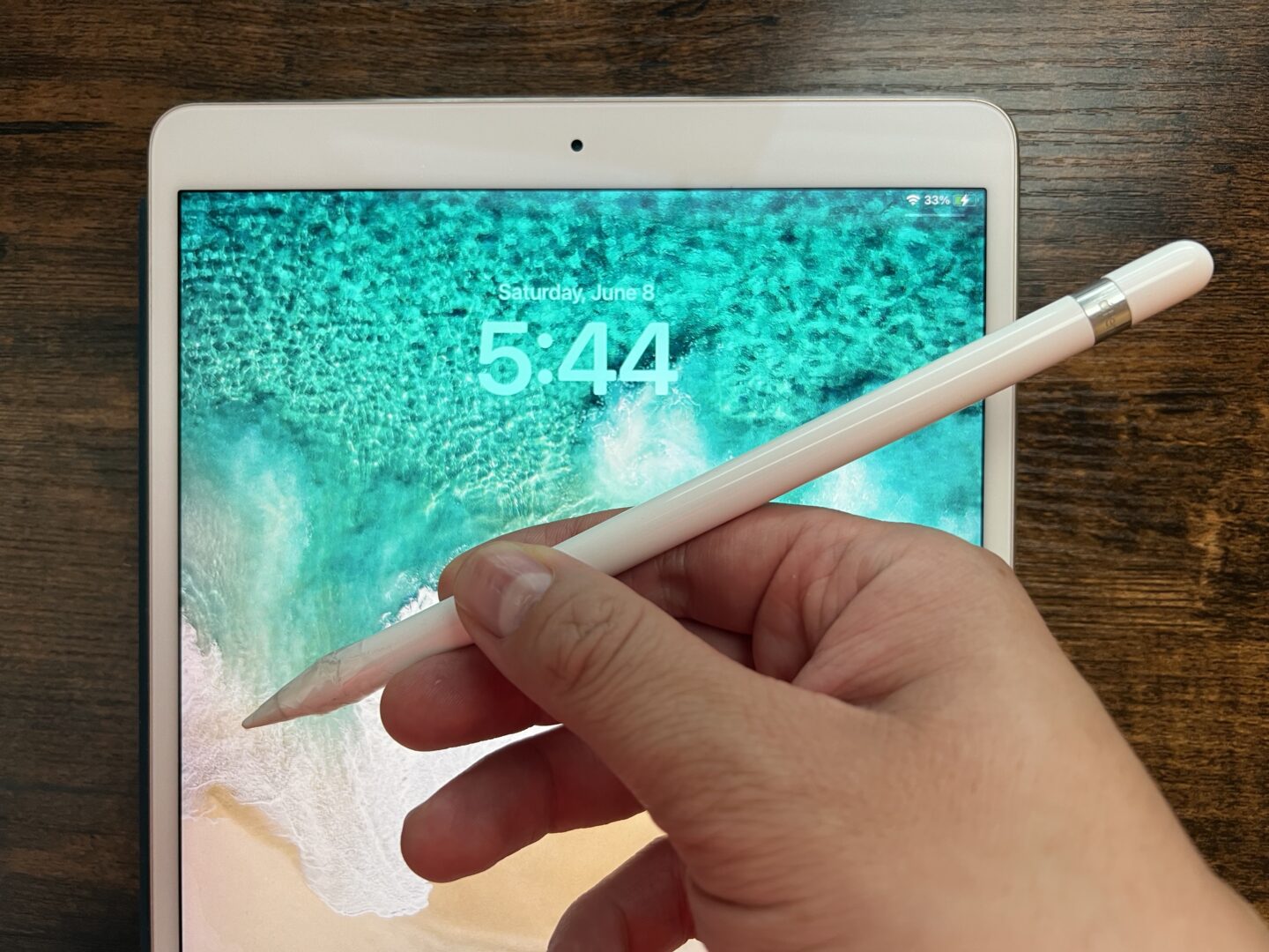 Apple Pencil (1st generation) in front of 10.5-inch iPad Pro